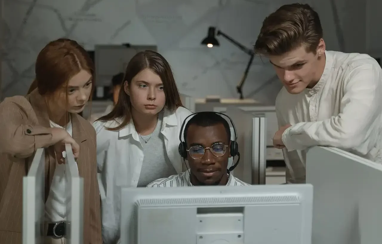 IT support team working together at a computer
